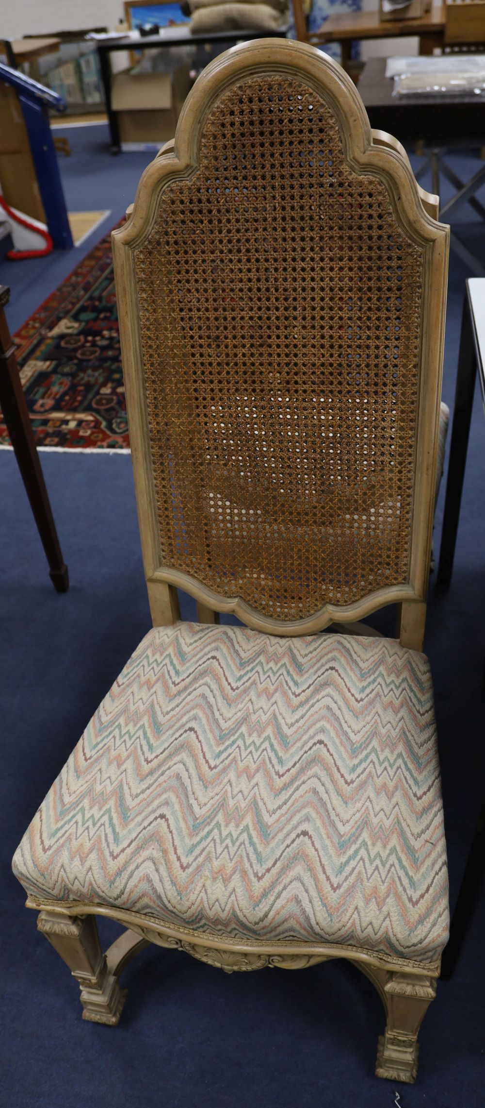 A set of four caned high back dining chairs